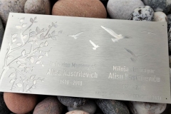 Anodēta alumīnija plāksnīte soliņam parkā.